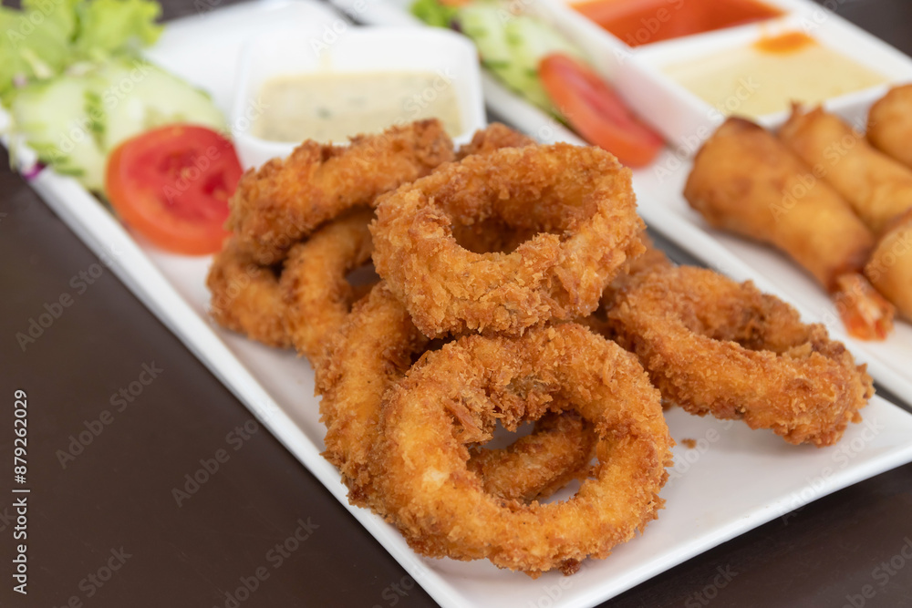 Salt and pepper squid deep-fried or Calamari on a white plate. Salt and pepper squid deep-fried or Calamari on a white plate.
