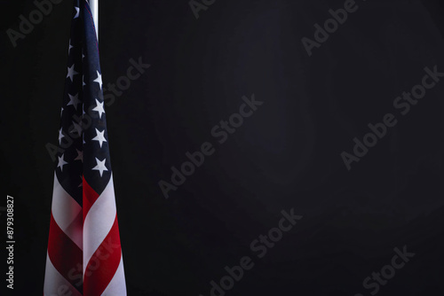 Photo of American flag on a black background with copy space, in a closeup view. USA national symbol for United States holidays or celebrations. Banner design template. Isolated on a studio backdrop.