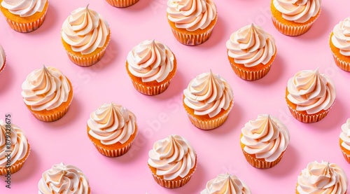 Pattern with vanilla cupcakes on light pink background, minimal flat lay style. Creative food background.