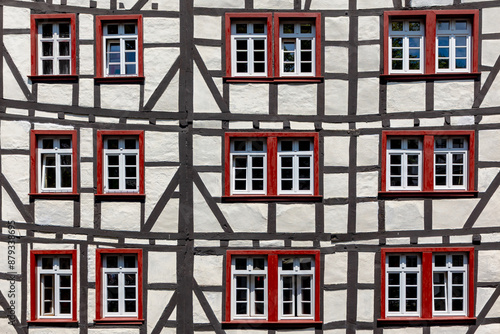 Half-timbered (Fachwerk) medieval style, Framed houses are build after an old construction technique, The houses show wooden beams in their walls, Monschau, Eifel, Germany, Abstract pattern background © Sarawut
