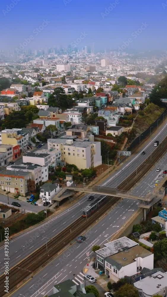Sunny city with beautiful architecture at daytime. Transport moving by the motorways. Aerial perspective. Vertical video Sunny city with beautiful architecture at daytime. Transport moving by the motorways. Aerial perspective. Vertical video