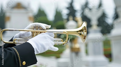 A trumpeter in white gloves plays a somber melody on a golden trumpet during a funeral ceremony at a cemetery
