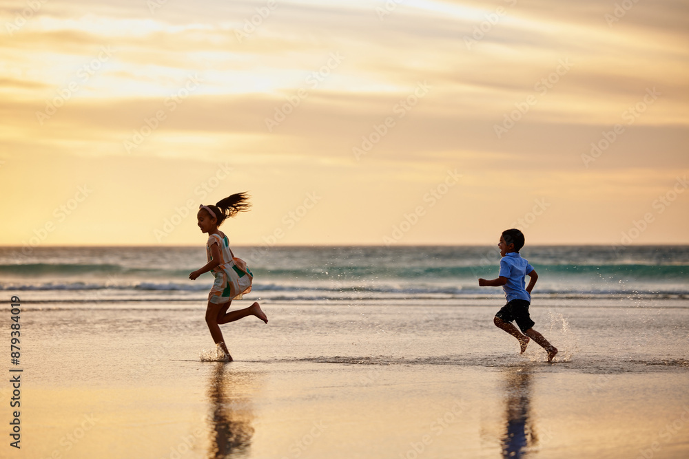 Fototapeta premium Beach, children and siblings running at sunset for playing games and enjoying exercise on ocean trip. Travel, kids and brother on sand at sea chasing sister in nature for holiday vacation or weekend