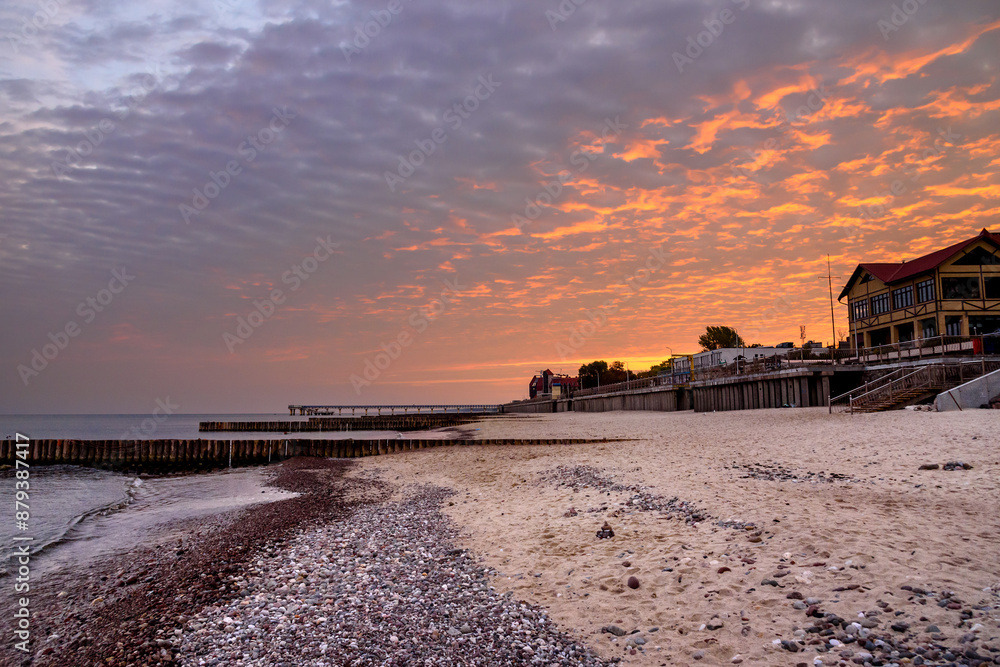 View of sand beach with wooden breakwaters on the Baltic Sea coast on sunrise in Zelenogradsk. Russia