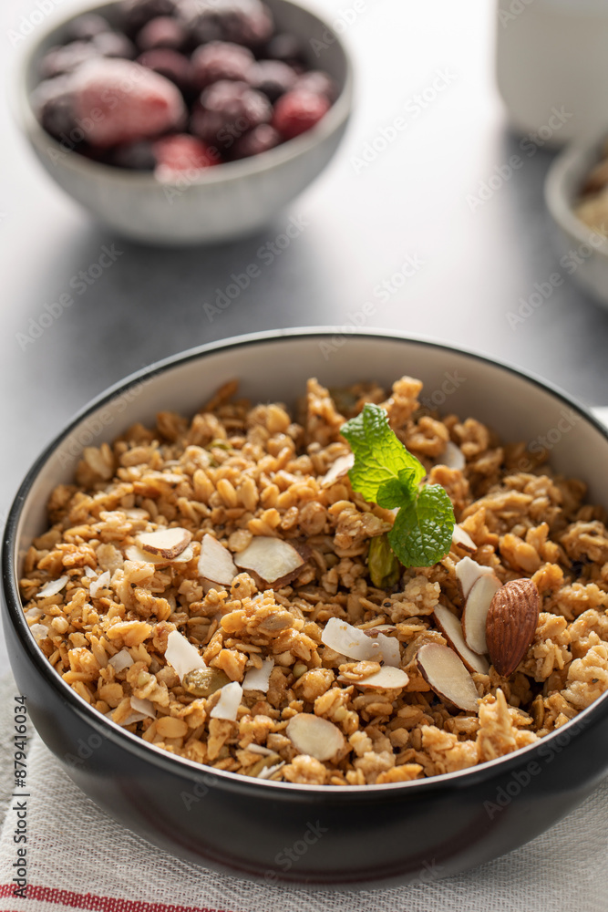 Crispy homemade granola with sliced almonds in a bowl. Healthy food Crispy homemade granola with sliced almonds in a bowl. Healthy food