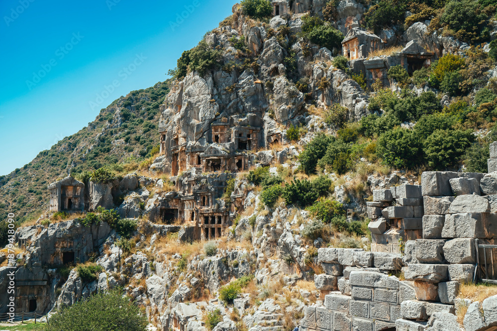 Naklejka premium Myra Ancient City. Ancient Lycian rock tombs are stone tombs in Turkey. Historical ancient place in Demre. Antalya, Turkey.