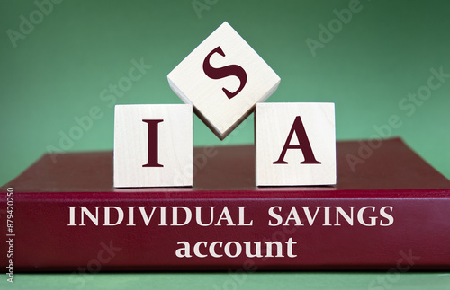 Fotografie ISA - acronym on large wooden cubes on the background of a burgundy folder with