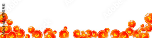 Vitamin E round capsules scattered randomly.
