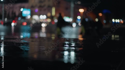Wallpaper Mural Blurred view of cars passing with headlights on a wet city street at night, creating vibrant light reflections Torontodigital.ca