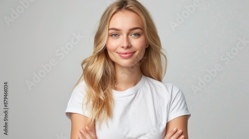 Portrait of blonde woman in white tshirt smiling at camera over isolated background