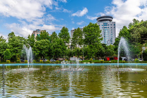 A view across a lake in a park beside the Skanderbeg Square in central Tirana, Albania in summertime photo