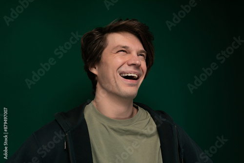 Man Laughing in Front of Green Background photo