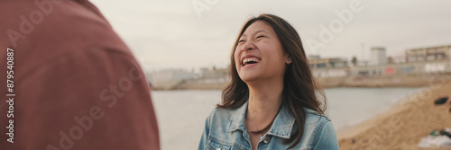 Young couple are talking to each other on the seascape, panorama
