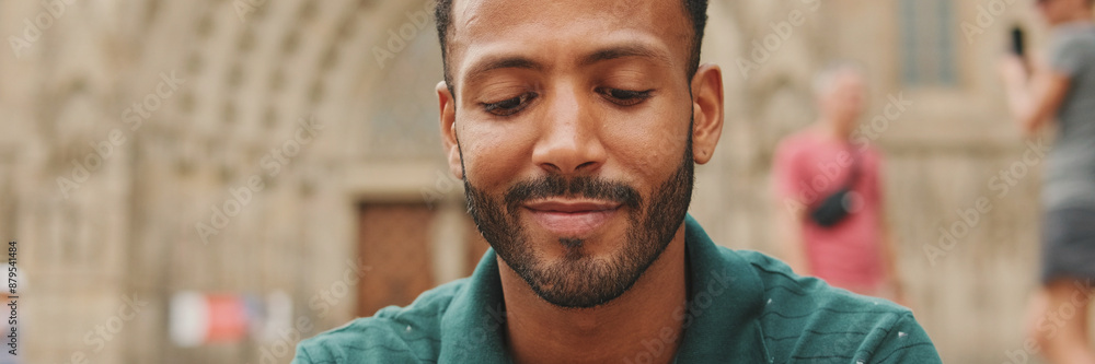 Obraz premium Close up, young man sitting on the steps of the Sagrada Familia in Barcelona