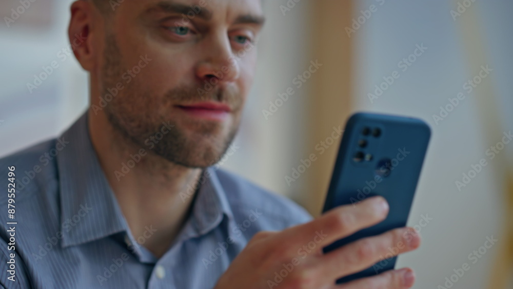 Closeup guy hands scrolling mobile phone at light apartment. Man browsing feed Closeup guy hands scrolling mobile phone at light apartment. Man browsing feed