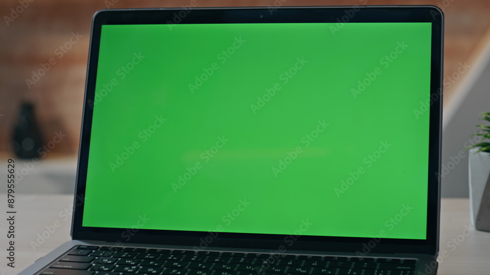 Empty chroma key laptop display on workplace desk closeup. Green screen computer Empty chroma key laptop display on workplace desk closeup. Green screen computer