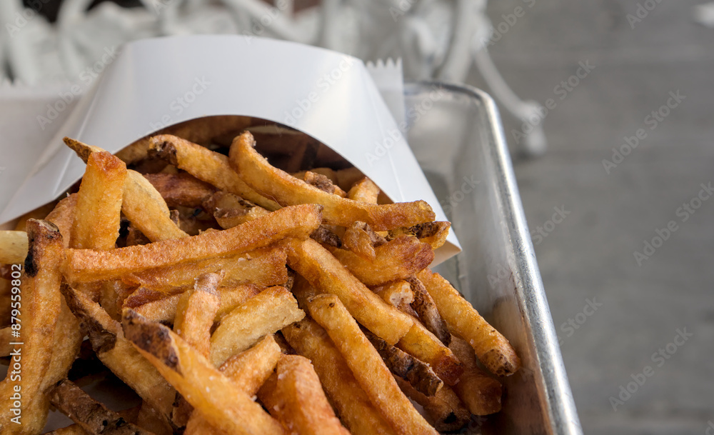 close up of french fries in a white container holder (potato potatoes fast food) americana chips frites fritas (junk fried food) close up of french fries in a white container holder (potato potatoes fast food) americana chips frites fritas (junk fried food)