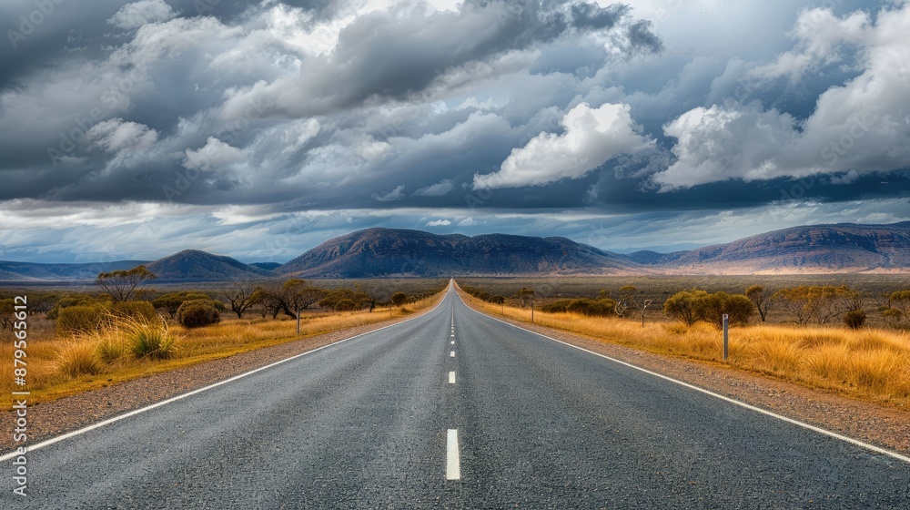 Straight road of Matilda Highway under thick clouds in the Queensland outback Straight road of Matilda Highway under thick clouds in the Queensland outback