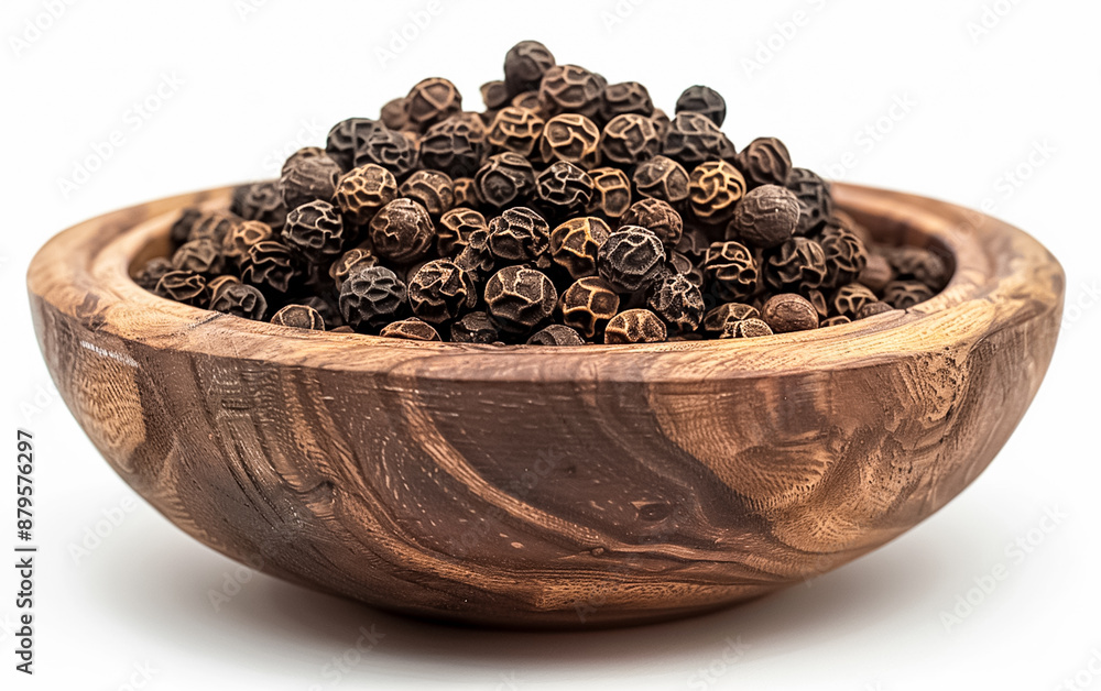 Black peppercorn in a wooden bowl. Black peppercorn in a wooden bowl.