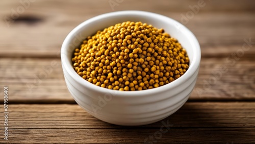  Golden grains in a white bowl on a wooden surface