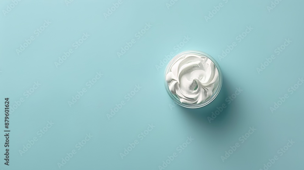 The top view of a face cream sample on a light blue background. The top view of a face cream sample on a light blue background.