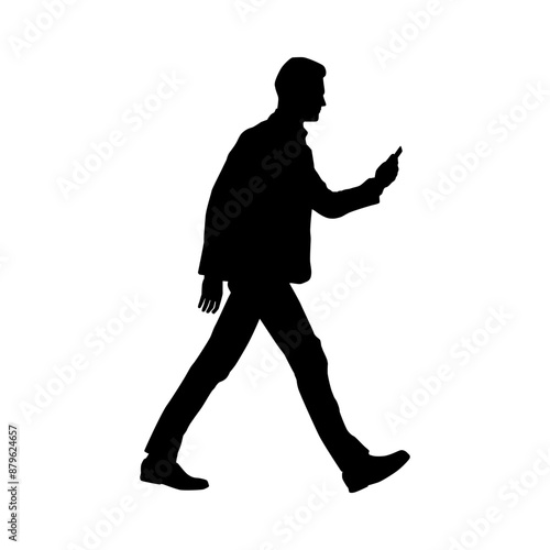 Silhouette of a man walking while using a smartphone