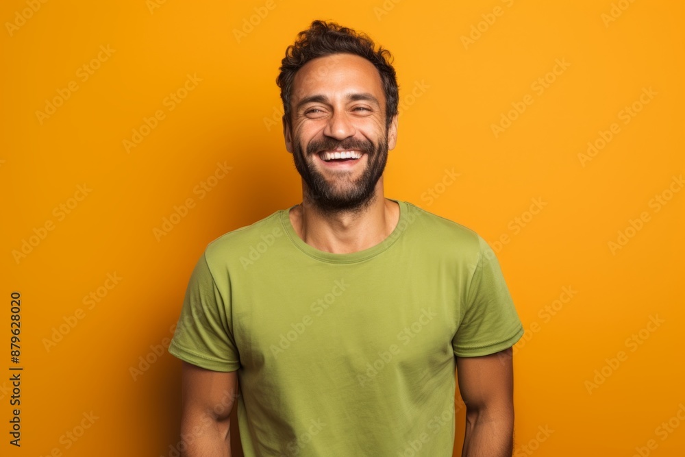 Portrait of a smiling man in his 30s donning a trendy cropped top over solid color backdrop Portrait of a smiling man in his 30s donning a trendy cropped top over solid color backdrop
