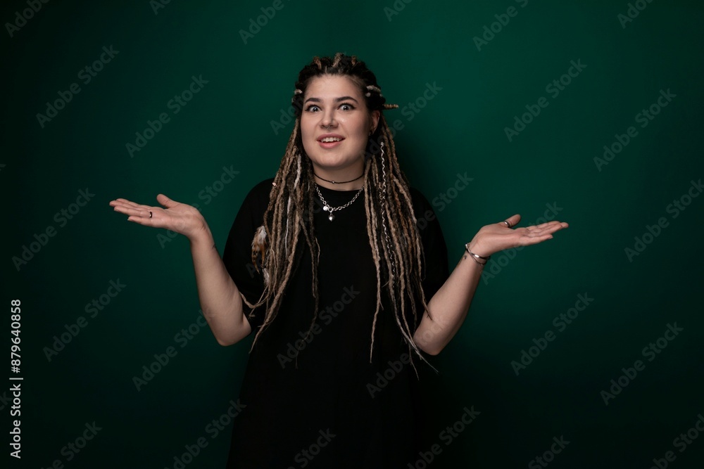 Woman With Dreadlocks Standing in Front of Green Background Woman With Dreadlocks Standing in Front of Green Background
