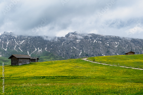 Seiser Alm - Wanderparadies in den Südtiroler Dolomiten. Saftig grüne Wiesen mit urigen Hütten umringt vor schroffen Berggipfeln auf der größten Hochalm Europas. photo