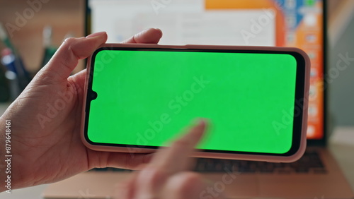 Closeup hands swiping mockup cellphone in office. Unknown woman watching content