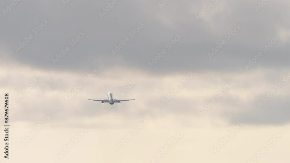 Rear view of a jet passenger plane with an unrecognizable livery taking off. Aircraft climbing at sunset sky Rear view of a jet passenger plane with an unrecognizable livery taking off. Aircraft climbing at sunset sky