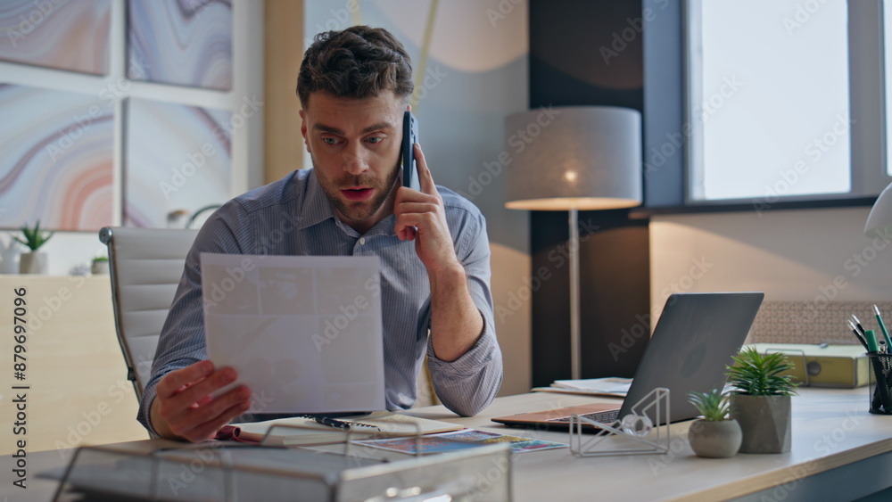 Naklejka premium Angry businessman talking smartphone in office closeup. Nervous man call phone
