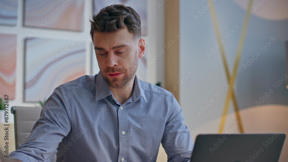 Focused man thinking project at computer table closeup. Designer sipping tea Focused man thinking project at computer table closeup. Designer sipping tea