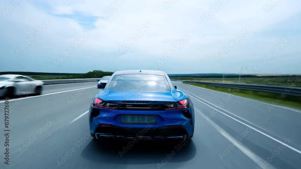 Blue automobile racing down a freeway at top speed. Blue automobile racing down a freeway at top speed.
