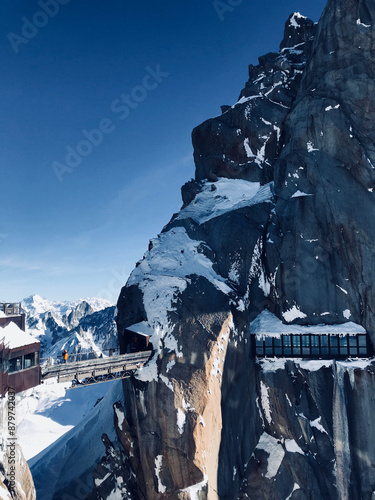 Snow-Covered Cliffs and Observation Deck at Chamonix-Mont-Blanc with Clear Blue Sky photo