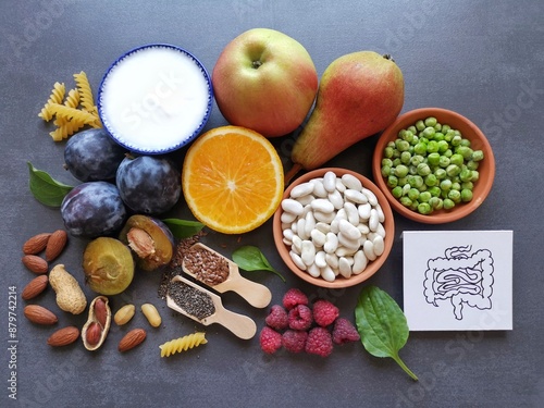 High fiber foods for healthy bowel. Healthy foods for intestine health. Diet and nutrition for constipation. Assortment of foods for healthy gut and digestive system with intestine anatomical drawing.