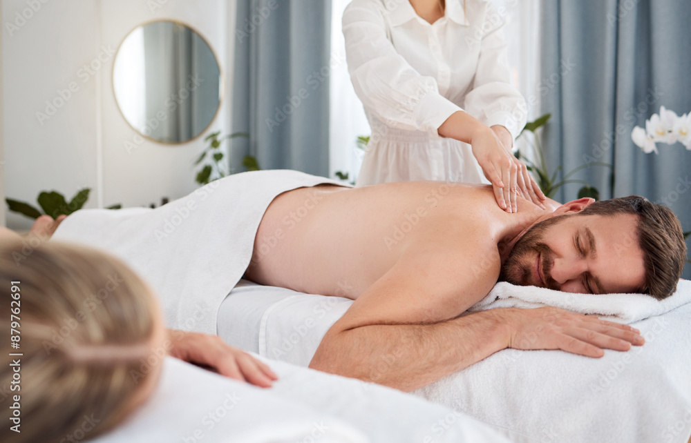 Relax, back massage and man with couple for wellness, peace or calm for health on bed at spa. Therapy, hands or masseuse with client for shiatsu, body treatment or luxury service for healing at salon Relax, back massage and man with couple for wellness, peace or calm for health on bed at spa. Therapy, hands or masseuse with client for shiatsu, body treatment or luxury service for healing at salon