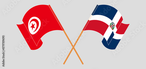 Crossed and waving flags of Tunisia and Dominican Republic