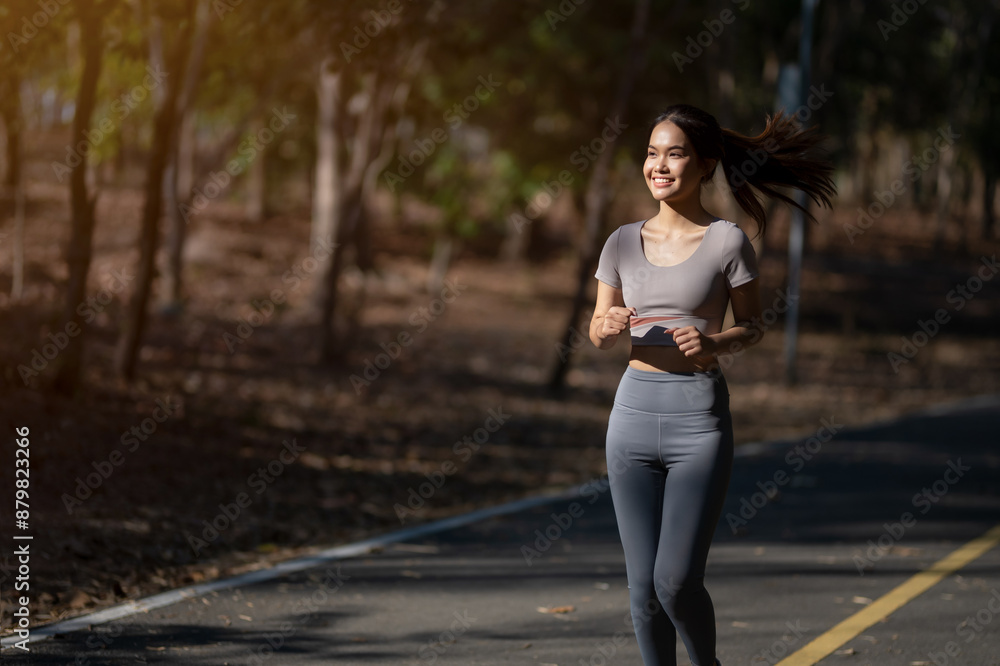 A woman is running on a path in the woods A woman is running on a path in the woods
