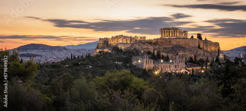 Panoramic view of the Acropolis of Athens, Greece, with lights on, at dawn from Pnyx Hill