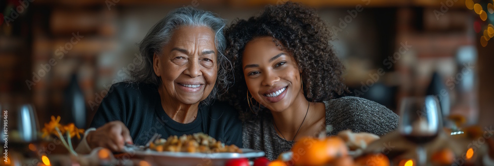 Elderly woman and young woman smiling at a Thanksgiving dinner table, surrounded by festive decorations. Concept of family celebration, gratitude, and holiday joy Elderly woman and young woman smiling at a Thanksgiving dinner table, surrounded by festive decorations. Concept of family celebration, gratitude, and holiday joy