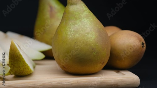 a green pear on a dark background