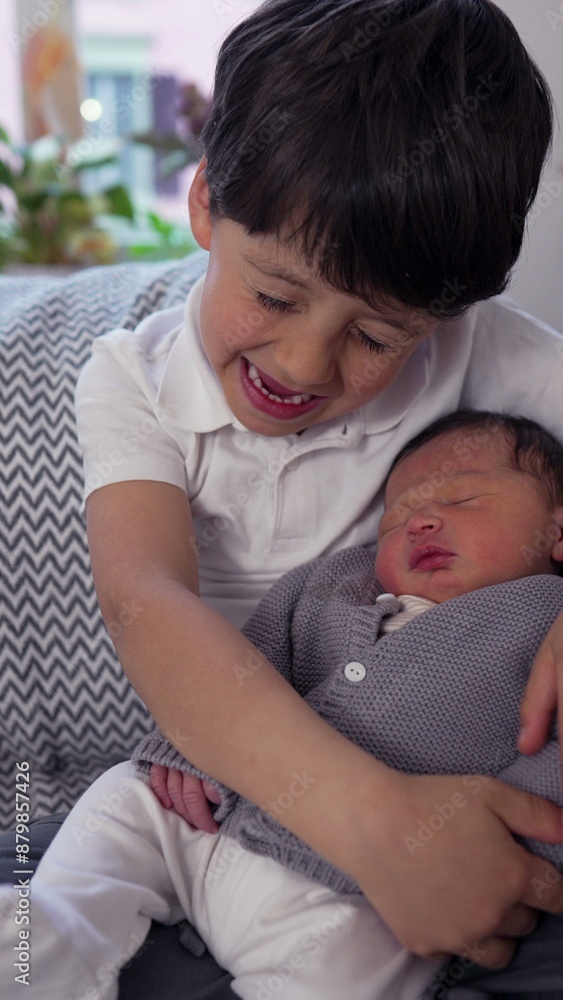 Young boy affectionately cradling his newborn sibling on a couch, surrounded by cozy home decor, highlighting their close bond and sibling love Young boy affectionately cradling his newborn sibling on a couch, surrounded by cozy home decor, highlighting their close bond and sibling love