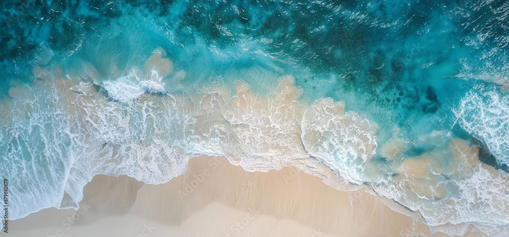 Ocean waves washing up on a sandy beach. View from above Ocean waves washing up on a sandy beach. View from above