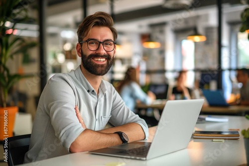 Happy entrepreneur working on laptop