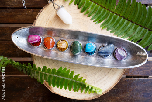 Canvas Print seven chakras stones over wooden background, energy healing concept