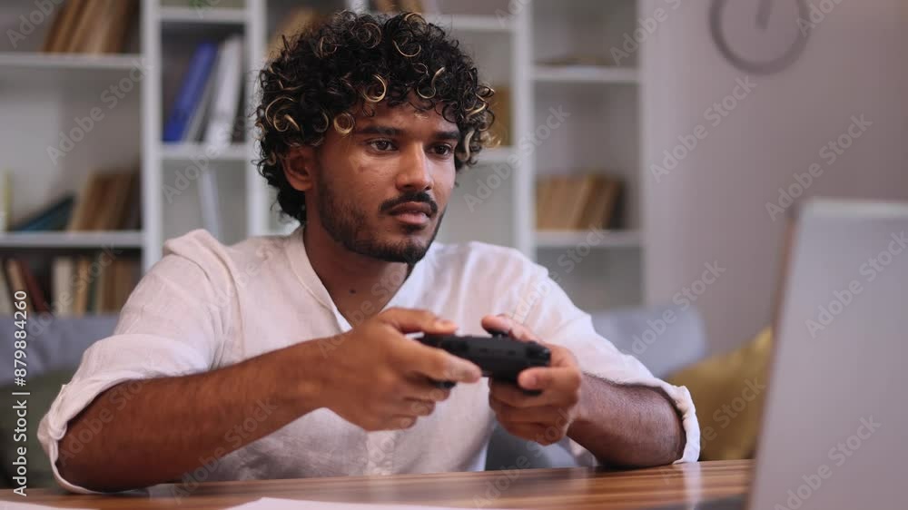 Boring young man play uninteresting game on laptop computer feels disappointed at desktop Upset male with joystick controller looking at screen without enthusiasm at home Boring young man play uninteresting game on laptop computer feels disappointed at desktop Upset male with joystick controller looking at screen without enthusiasm at home