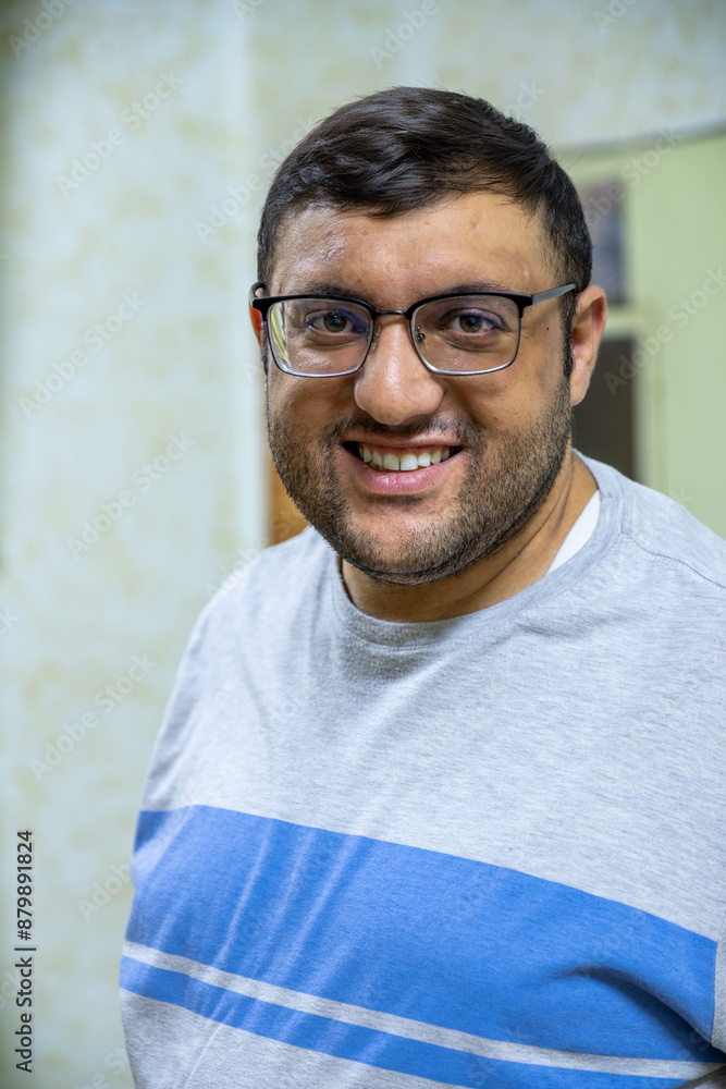 Man in glasses, smiling and relaxed at home, captured in candid portraits. Sitting on an armchair, wearing casual shirts. Perfect for lifestyle and everyday moments themes Man in glasses, smiling and relaxed at home, captured in candid portraits. Sitting on an armchair, wearing casual shirts. Perfect for lifestyle and everyday moments themes