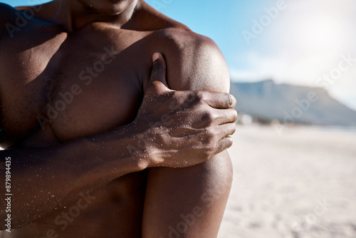 Fitness, shoulder pain and man on beach with injury for arm inflammation, muscle strain or ache. Suffering, body and hand of athlete with discomfort for sprain, emergency or exercise accident