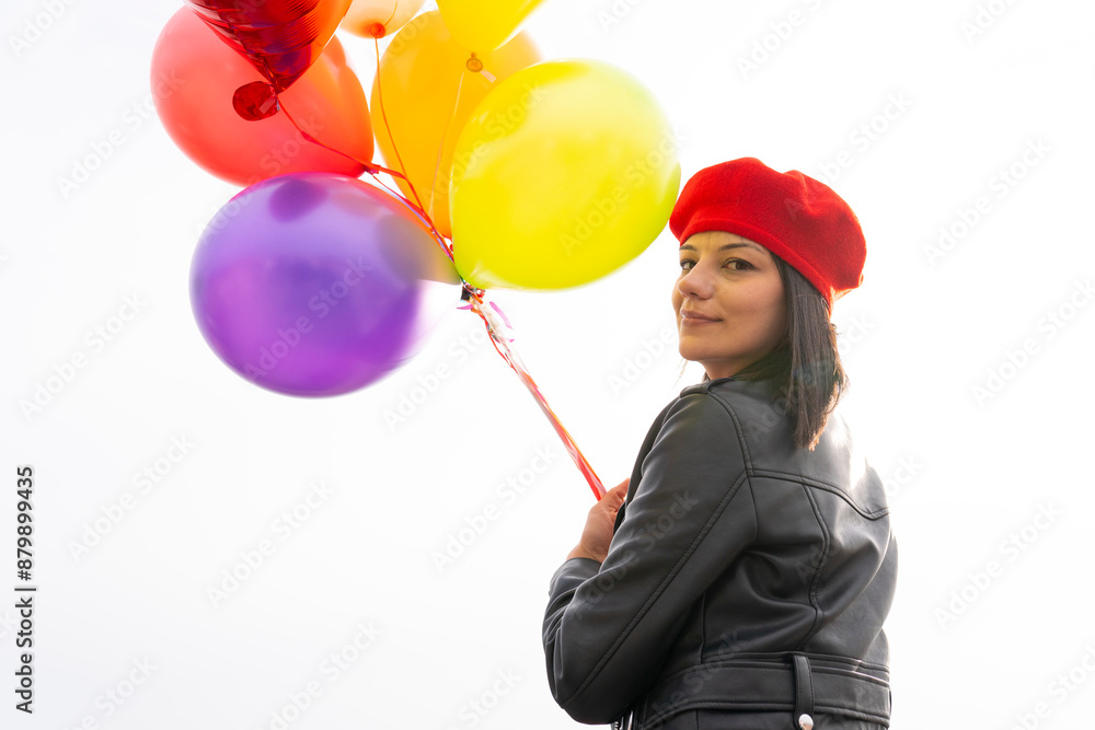 woman holding colorful balloons against the sky woman holding colorful balloons against the sky